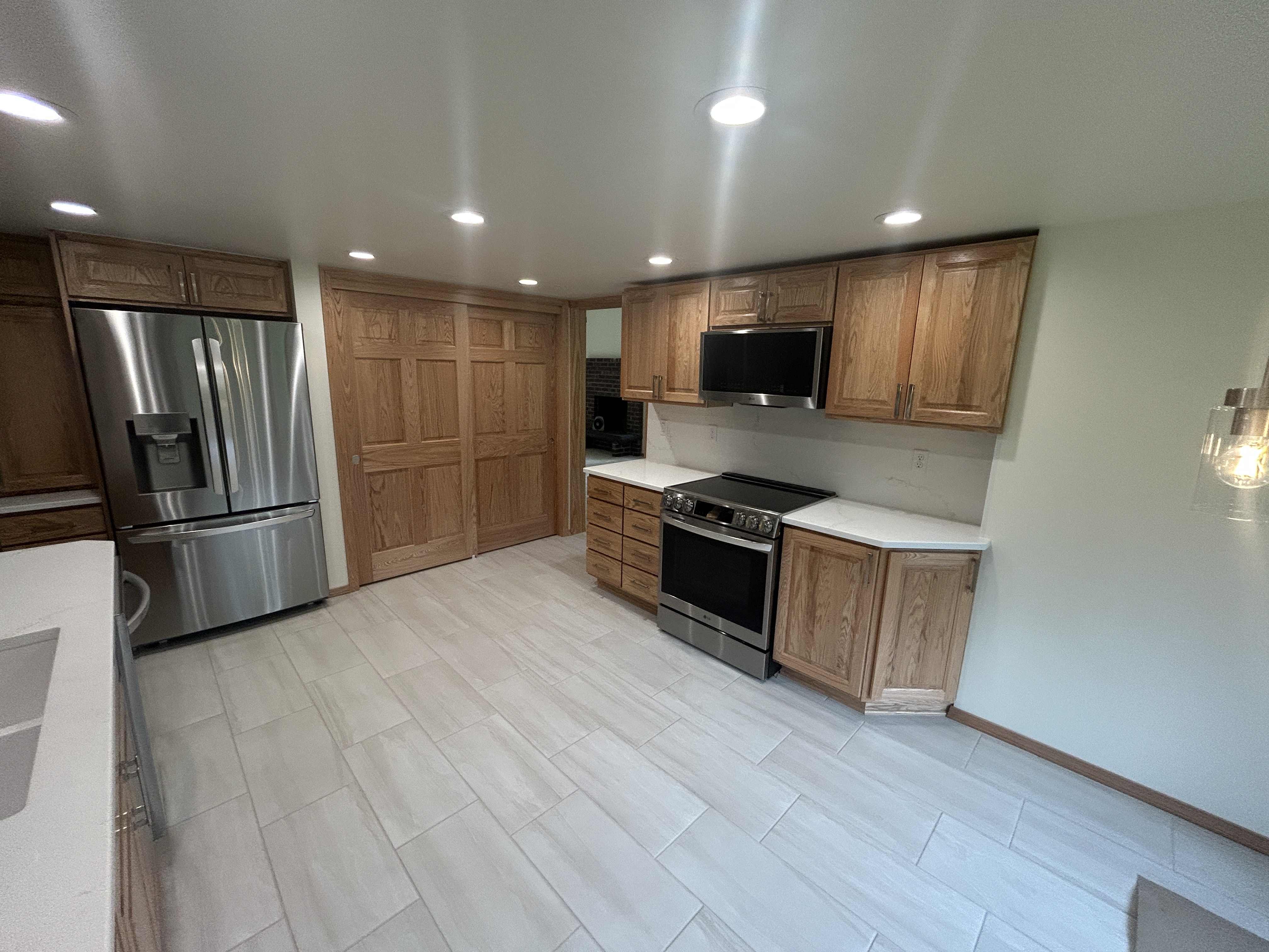 Restored kitchen with oak cabinets and new appliances