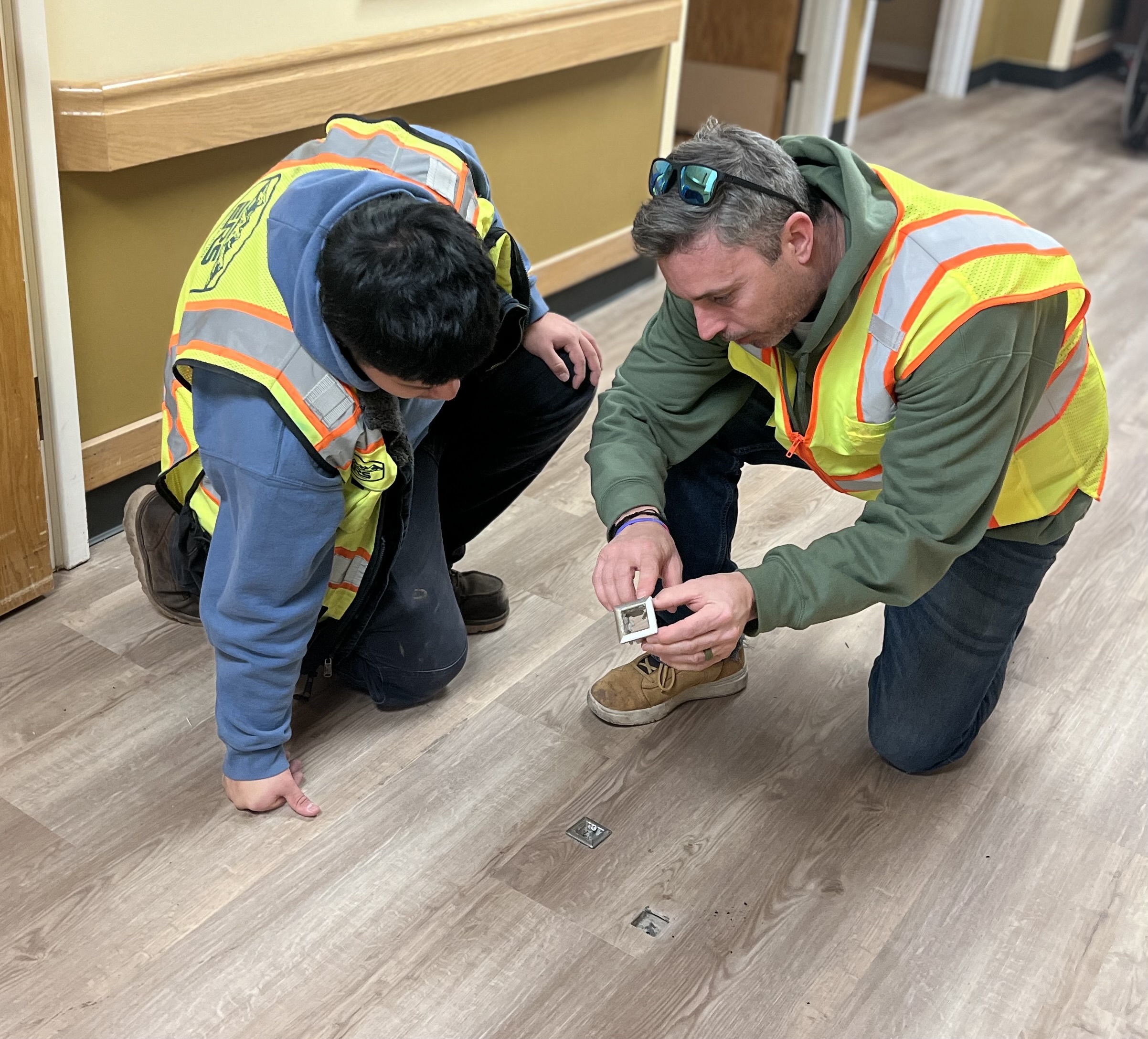 Team inspecting flooring installation