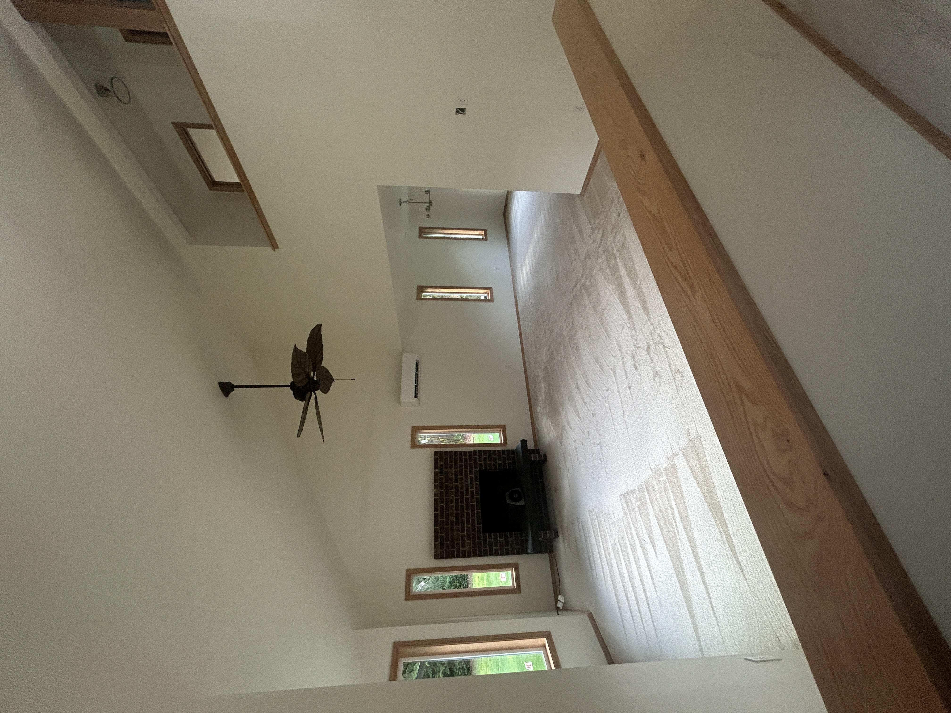 Restored living room with vaulted ceiling and brick fireplace